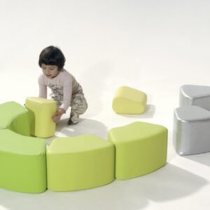 Modular arch-shaped soft blocks in bright colours, arranged as semicircles and arches, with washable fireproof covers.