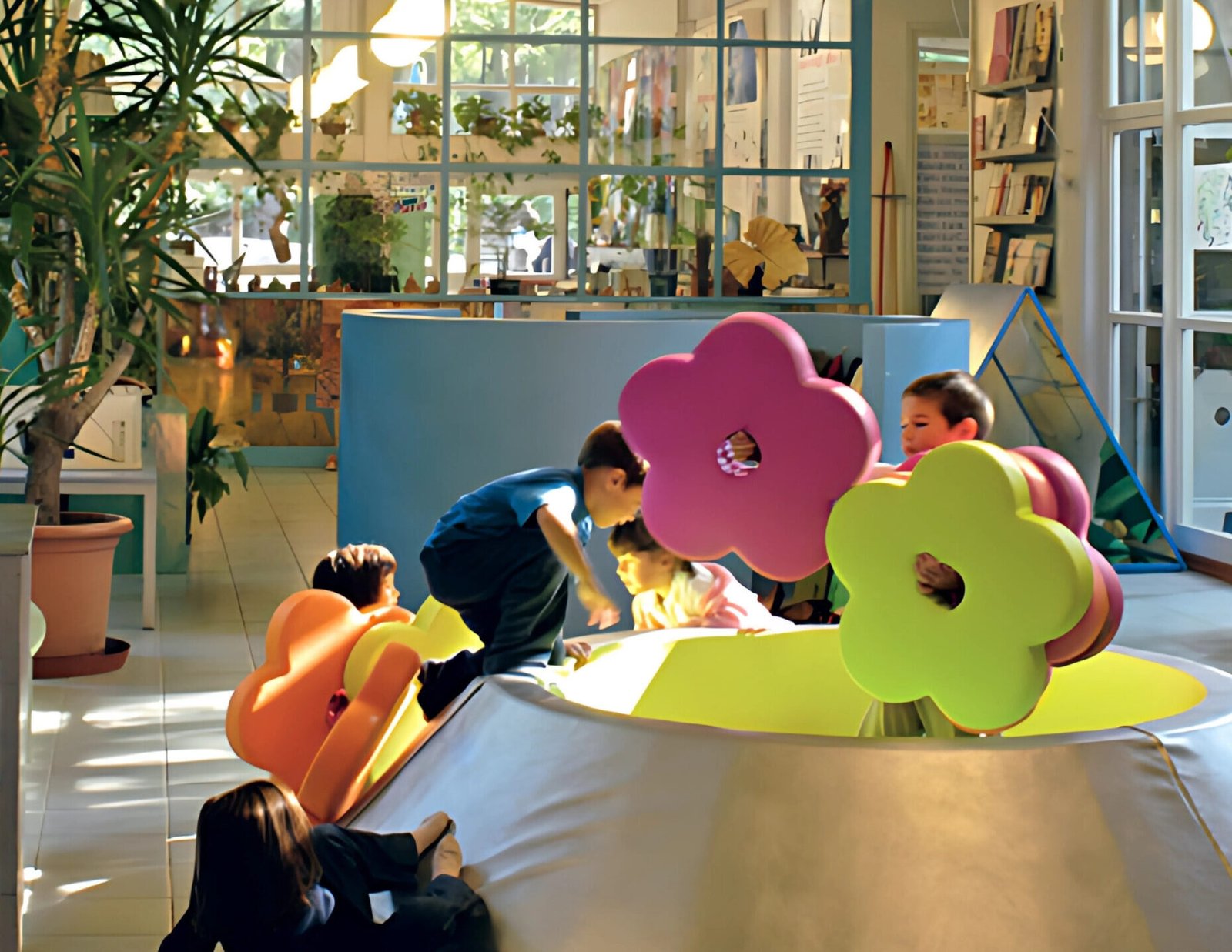 Children exploring a Reggio Emilia-inspired classroom with modular PLAY+ furniture made in Italy.
