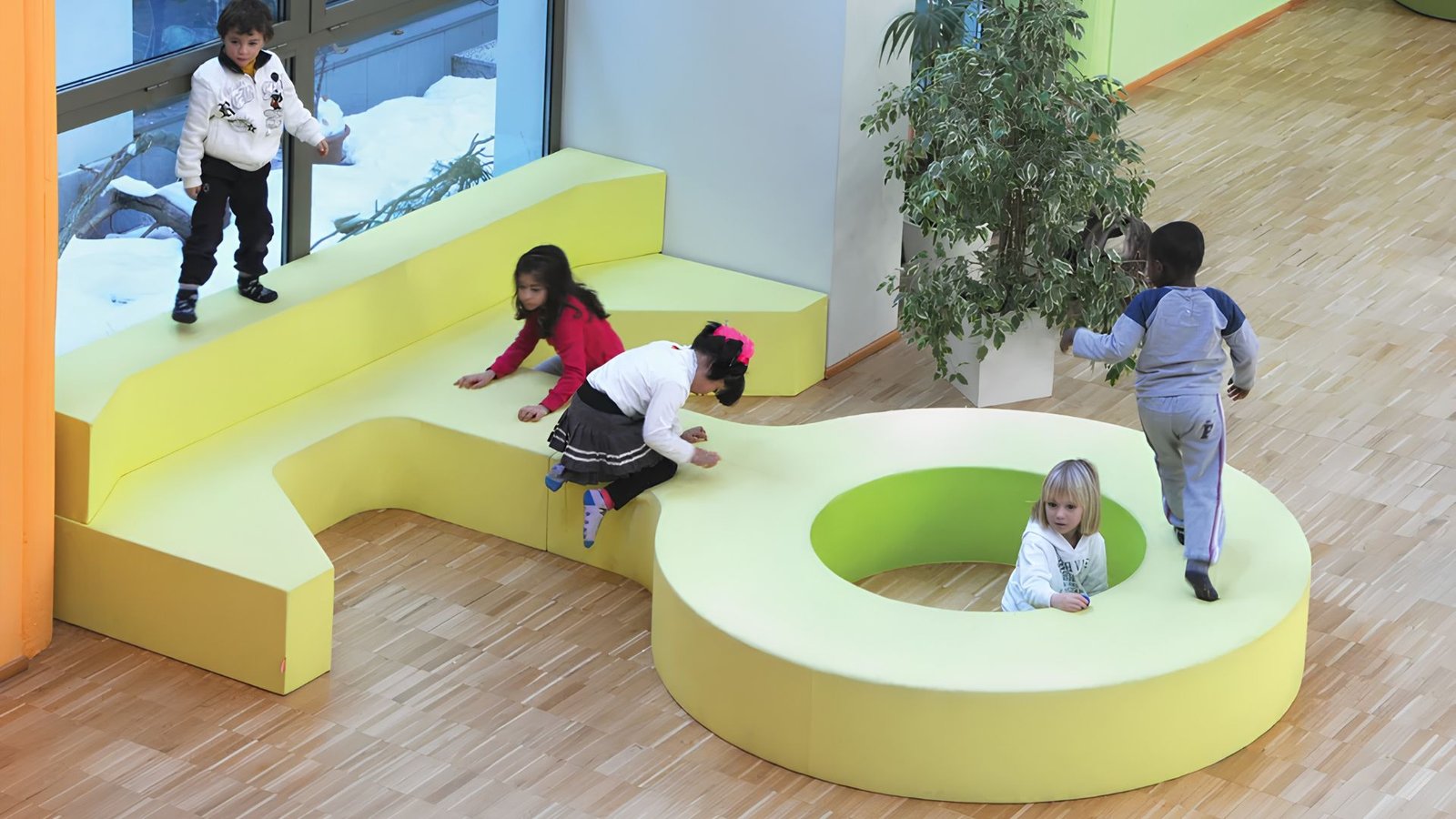Tiered modular seating with a central play space for collaborative learning and storytelling.