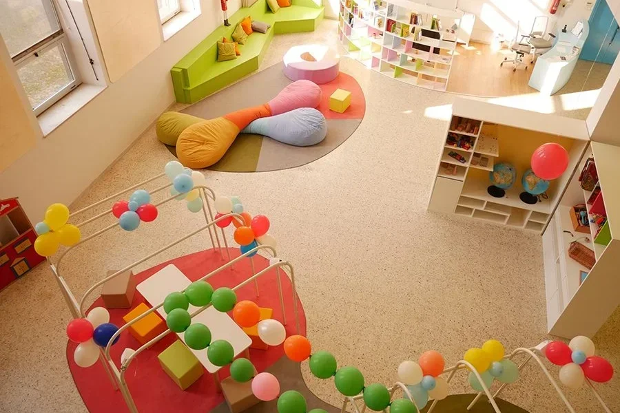 Oversized soft seating cushions creating a flexible reading and relaxation area