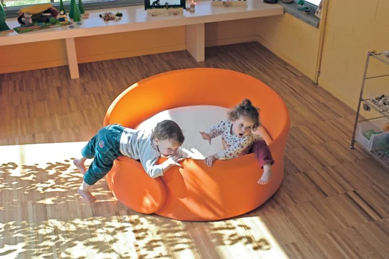 Child relaxing inside Cocoon enclosed play space