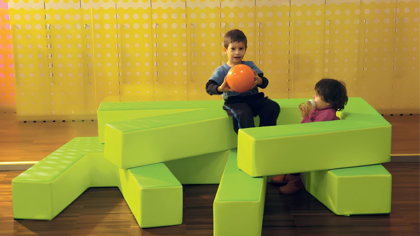 Modular play landscape with pathways, seating and climbing elements for children